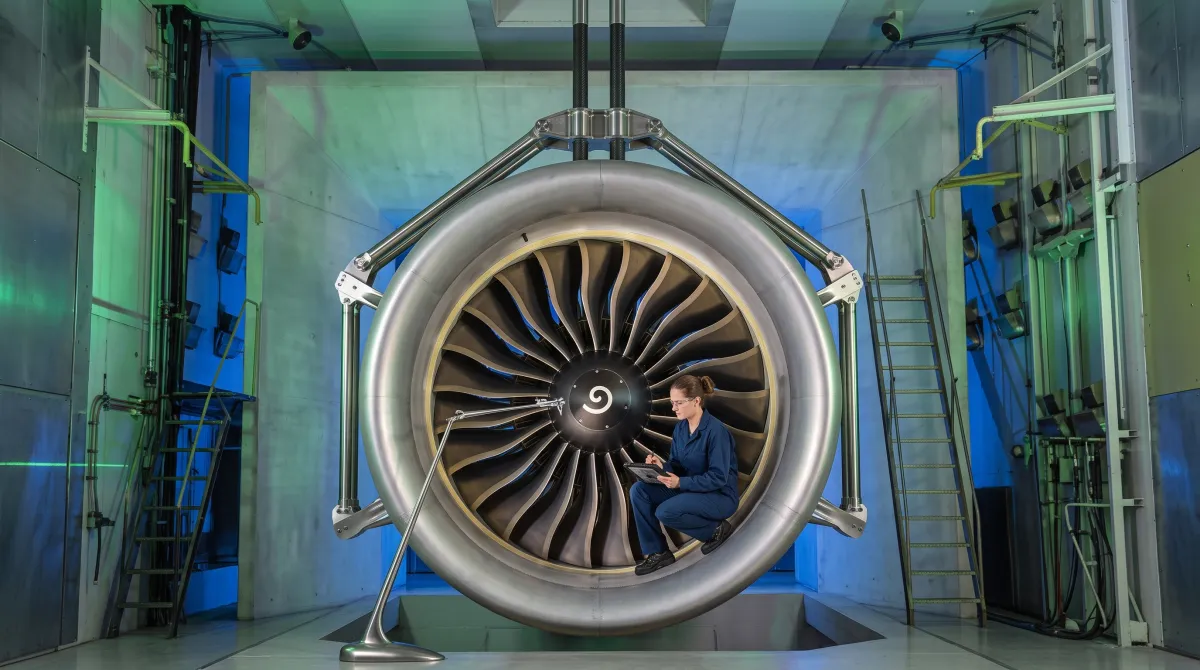 An aircraft mechanic inspecting an aircraft engine